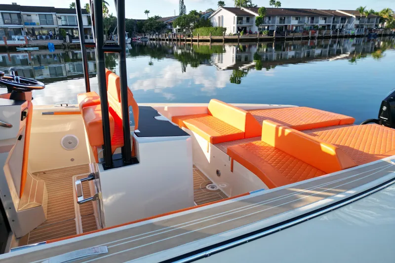  Yacht Photos Pics 2026 Lilybaeum Lipari 31 boat with orange seating, docked by waterfront homes.