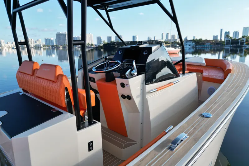  Yacht Photos Pics 2026 Lilybaeum Lipari 31 boat with orange seating, sleek design, and city skyline backdrop.