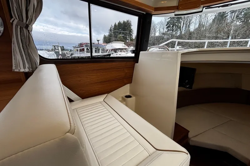  Yacht Photos Pics Interior of 2026 Ranger Tugs R-25 boat with white seating and window view.