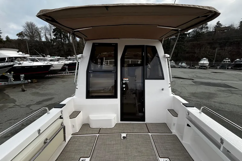  Yacht Photos Pics 2026 Ranger Tugs R-25 boat with covered deck, docked in a marina.