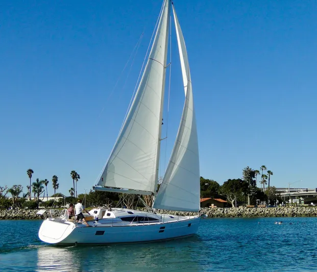 In Stock Now Yacht Photos Pics 2018 Elan 45 Impressions sailboat cruising on a sunny day with clear blue skies.