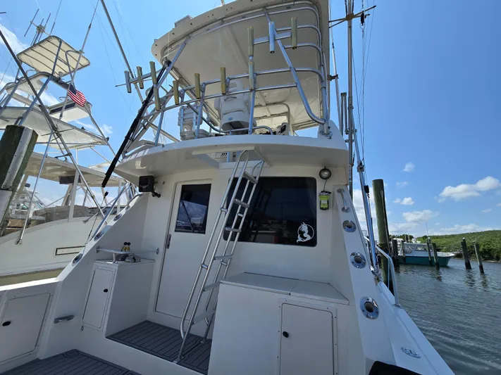  Yacht Photos Pics 1998 Henriques 38 Sportfisherman boat docked under clear blue sky.