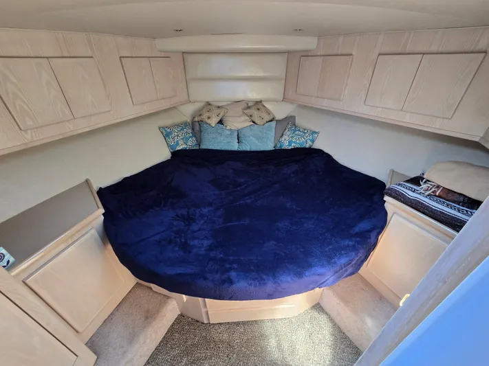  Yacht Photos Pics Cozy cabin interior of 1998 Henriques 38 Sportfisherman with plush bedding and storage cabinets.