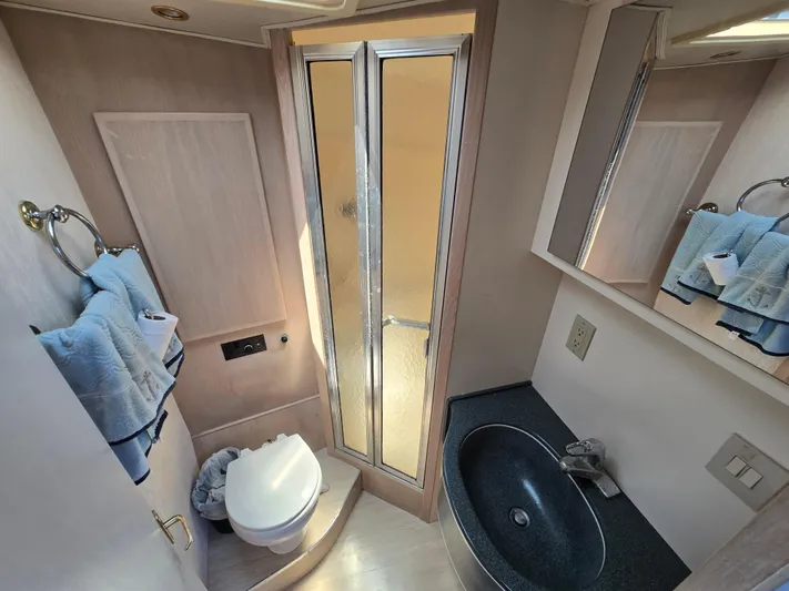  Yacht Photos Pics Bathroom interior of 1998 Henriques 38 Sportfisherman, featuring shower, sink, and toilet.