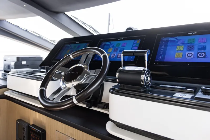 Chillin' Yacht Photos Pics Control panel of 2020 Azimut Grande 27 METRI yacht with modern navigation screens.