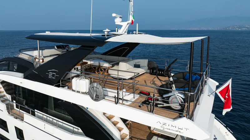 Chillin' Yacht Photos Pics Luxurious 2020 Azimut Grande 27 METRI yacht on open sea, featuring spacious upper deck.