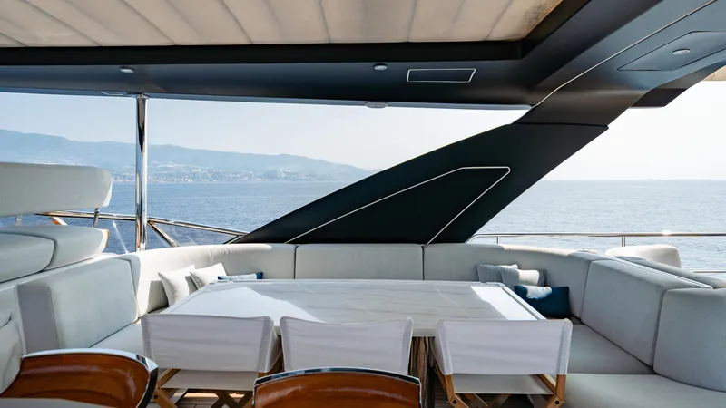 Chillin' Yacht Photos Pics Luxurious Azimut Grande 27 METRI yacht interior with ocean view, featuring elegant seating, 2020 model.