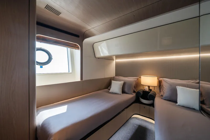 Chillin' Yacht Photos Pics Luxurious bedroom interior of 2020 Azimut Grande 27 METRI yacht with twin beds and modern decor.