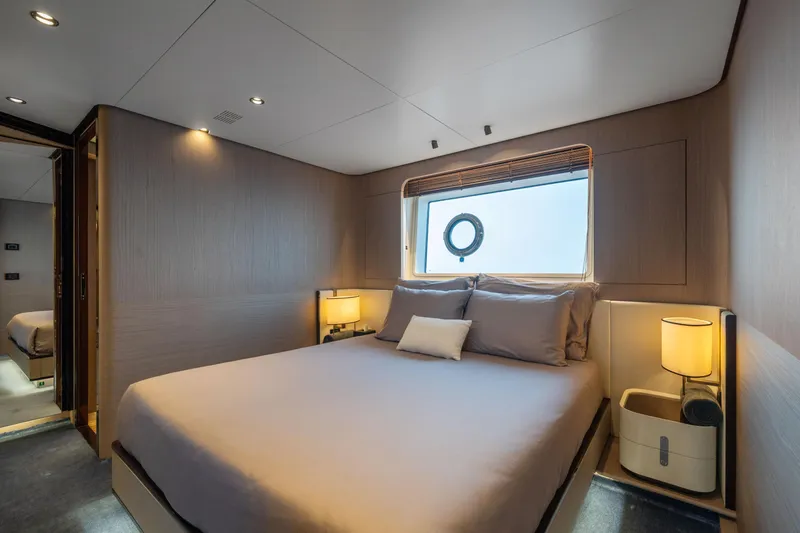 Chillin' Yacht Photos Pics Luxurious bedroom interior on 2020 Azimut Grande 27 METRI yacht, featuring modern design and cozy ambiance.