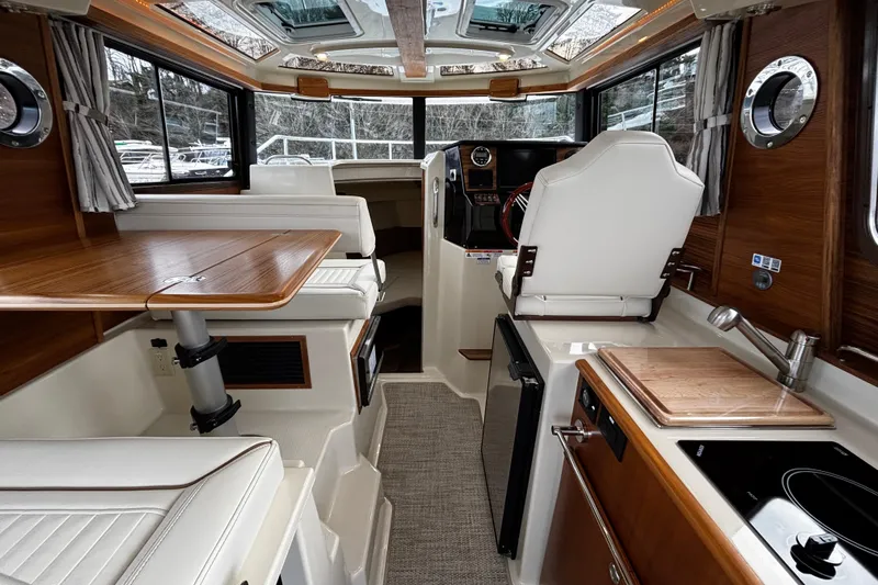  Yacht Photos Pics Interior of 2026 Ranger Tugs R-25 boat, featuring modern kitchen and seating area.