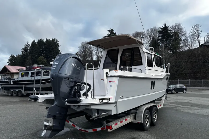  Yacht Photos Pics 2026 Ranger Tugs R-25 boat on trailer with Yamaha V6 engine, parked outdoors.