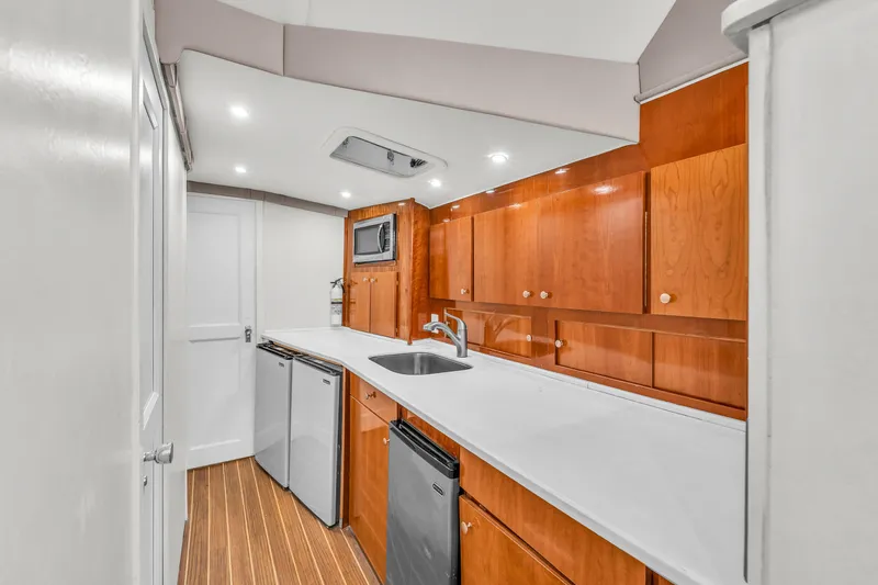  Yacht Photos Pics 1978 Hatteras 42 Convertible yacht kitchen with wood cabinets and modern appliances.