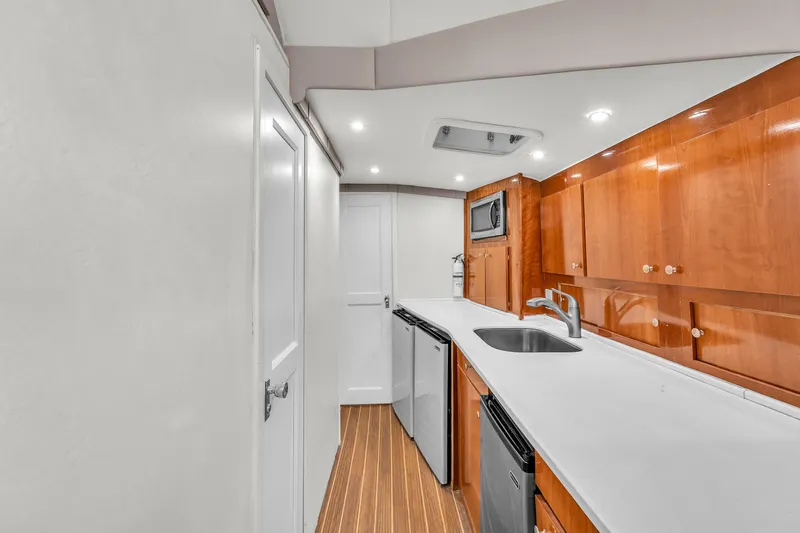  Yacht Photos Pics 1978 Hatteras 42 Convertible yacht kitchen with modern appliances and wooden cabinetry.