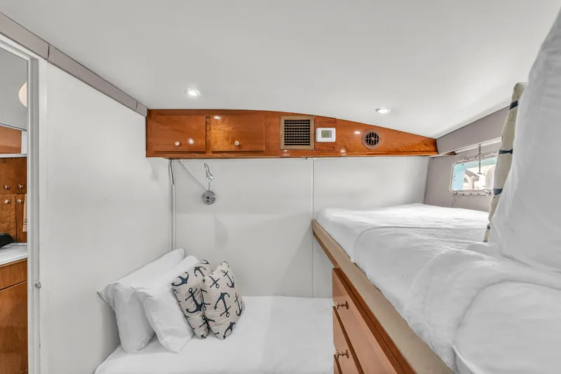  Yacht Photos Pics Cozy cabin interior of 1978 Hatteras 42 Convertible yacht with bunk beds and nautical decor.