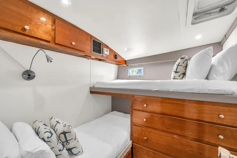  Yacht Photos Pics Cozy cabin interior of 1978 Hatteras 42 Convertible with wooden bunk beds and nautical decor.