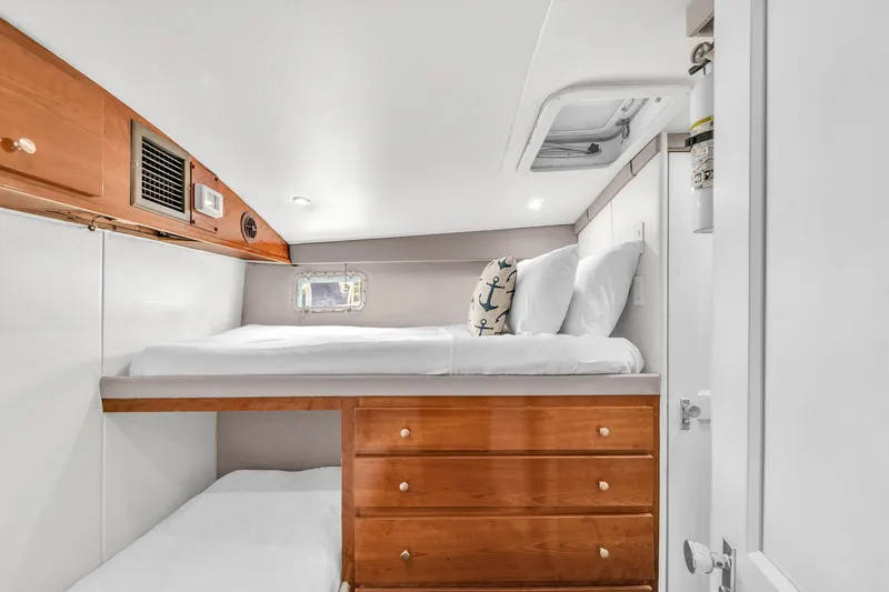  Yacht Photos Pics 1978 Hatteras 42 Convertible cabin with bunk beds and wooden storage drawers.