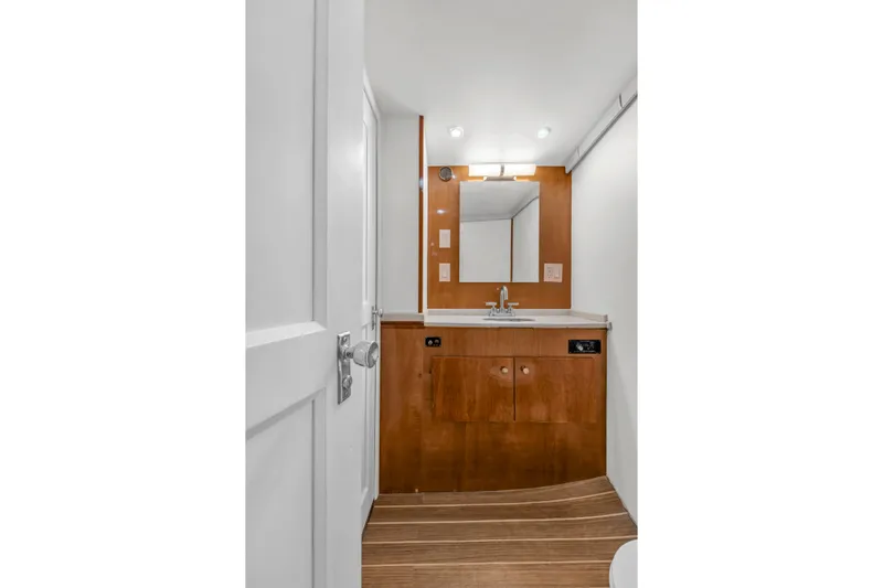  Yacht Photos Pics 1978 Hatteras 42 Convertible yacht bathroom with wooden cabinetry and modern fixtures.