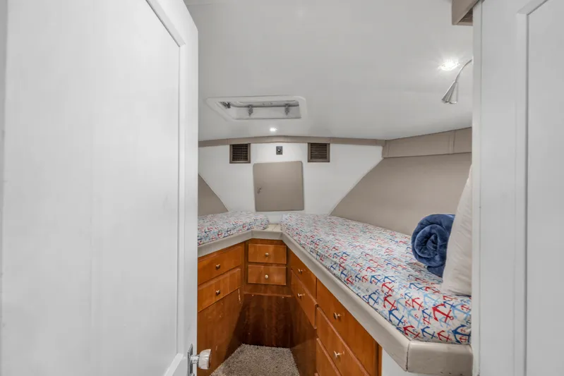  Yacht Photos Pics 1978 Hatteras 42 Convertible cabin with twin beds and wooden storage drawers.