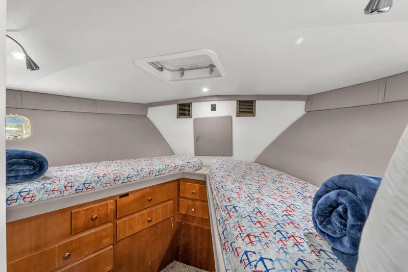  Yacht Photos Pics 1978 Hatteras 42 Convertible cabin with twin beds and anchor-themed bedding.