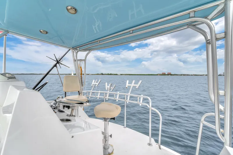 Yacht Photos Pics 1978 Hatteras 42 Convertible boat deck with ocean view and fishing rod holders.