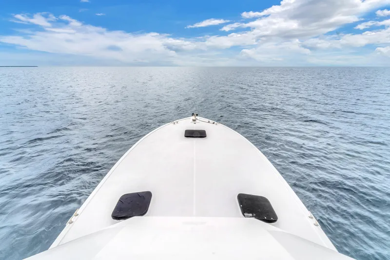  Yacht Photos Pics Bow view of 1978 Hatteras 42 Convertible yacht on open sea under blue sky.