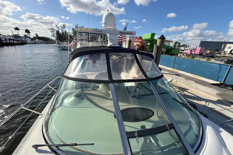  Yacht Photos Pics 1999 Sea Ray 410 Express Cruiser docked at marina under blue sky.