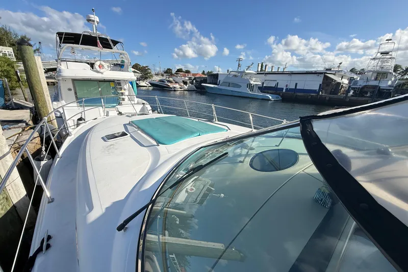  Yacht Photos Pics 1999 Sea Ray 410 Express Cruiser docked at marina under clear blue sky.