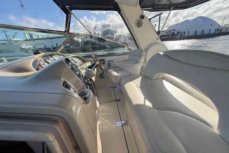 Yacht Photos Pics 1999 Sea Ray 410 Express Cruiser interior with helm and seating, docked at marina.
