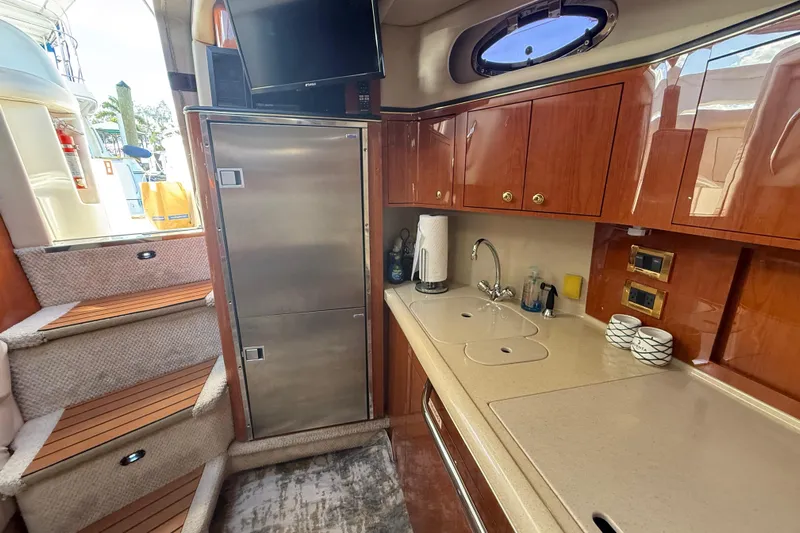  Yacht Photos Pics Interior of 1999 Sea Ray 410 Express Cruiser with kitchenette and stairs.