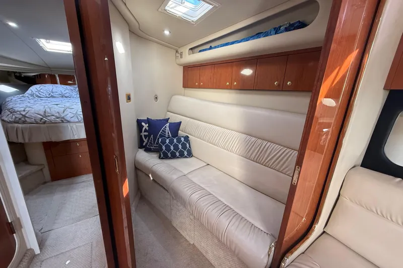  Yacht Photos Pics Luxurious interior of 1999 Sea Ray 410 Express Cruiser with cozy seating and elegant wood finishes.