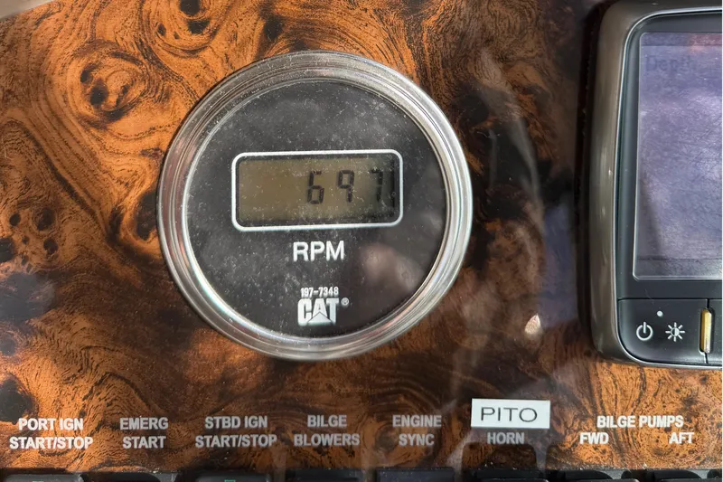  Yacht Photos Pics RPM gauge on 1999 Sea Ray 410 Express Cruiser dashboard, showing 697 RPM.