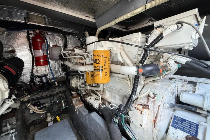  Yacht Photos Pics Engine room of a 1999 Sea Ray 410 Express Cruiser with visible components and fire extinguisher.