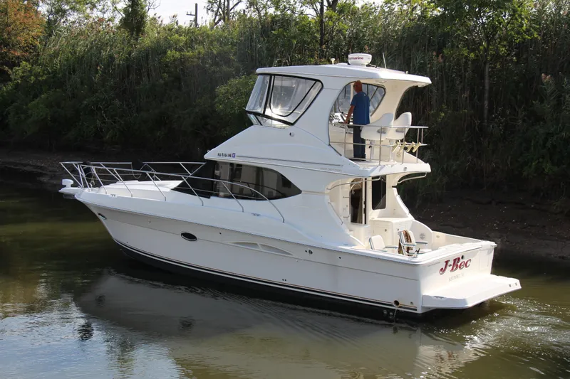  Yacht Photos Pics 2003 Silverton 38 Convertible yacht cruising on a calm river.
