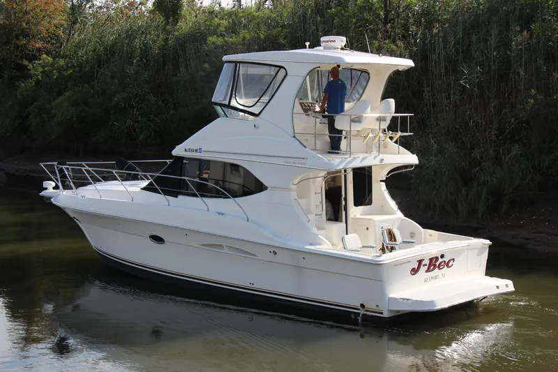  Yacht Photos Pics 2003 Silverton 38 Convertible yacht cruising on a calm river.