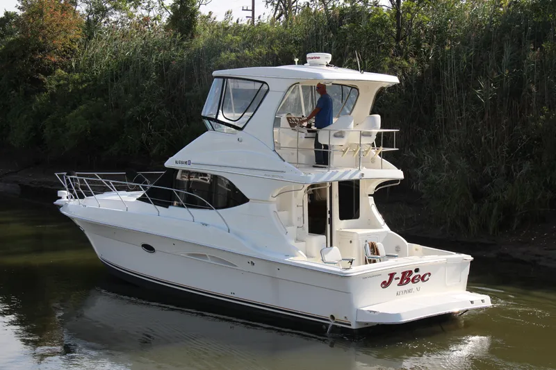  Yacht Photos Pics 2003 Silverton 38 Convertible yacht cruising on a calm river.