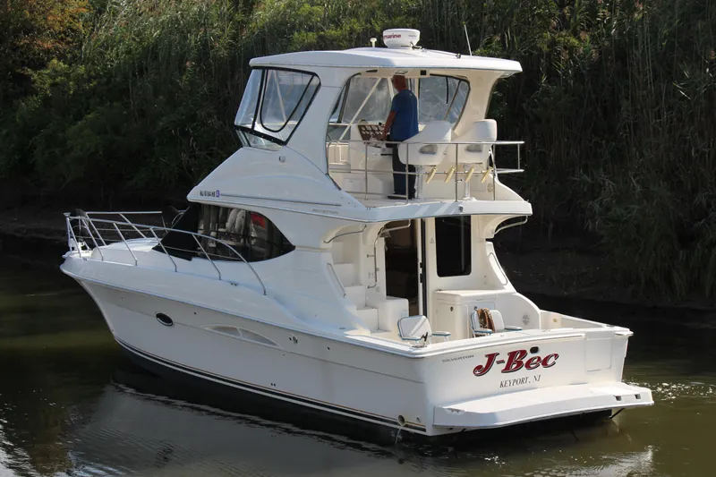  Yacht Photos Pics 2003 Silverton 38 Convertible yacht cruising on a calm river.