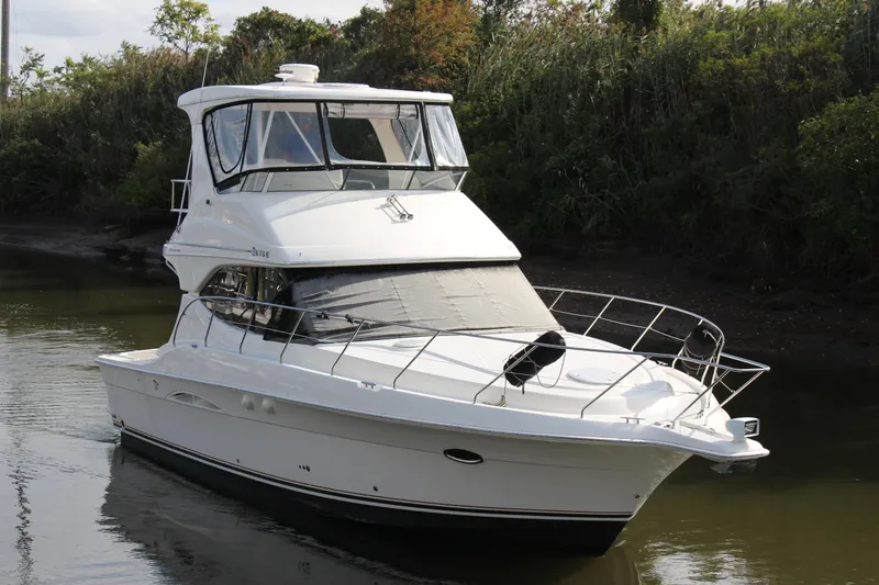  Yacht Photos Pics 2003 Silverton 38 Convertible yacht cruising on a calm river.