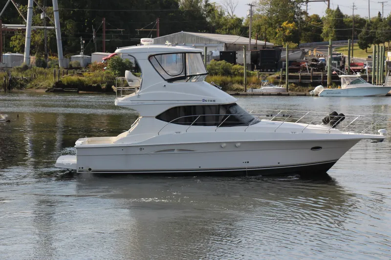  Yacht Photos Pics 2003 Silverton 38 Convertible yacht cruising on a calm river.