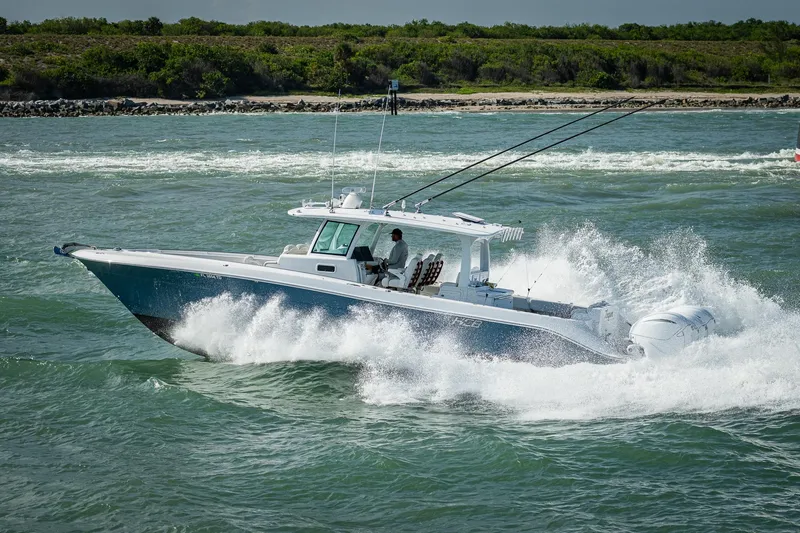 Tingum Yacht Photos Pics 2021 HCB 42 Lujo boat cruising on water with waves splashing.