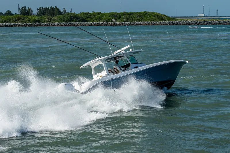 Tingum Yacht Photos Pics 2021 HCB 42 Lujo boat cruising through waves on a sunny day.