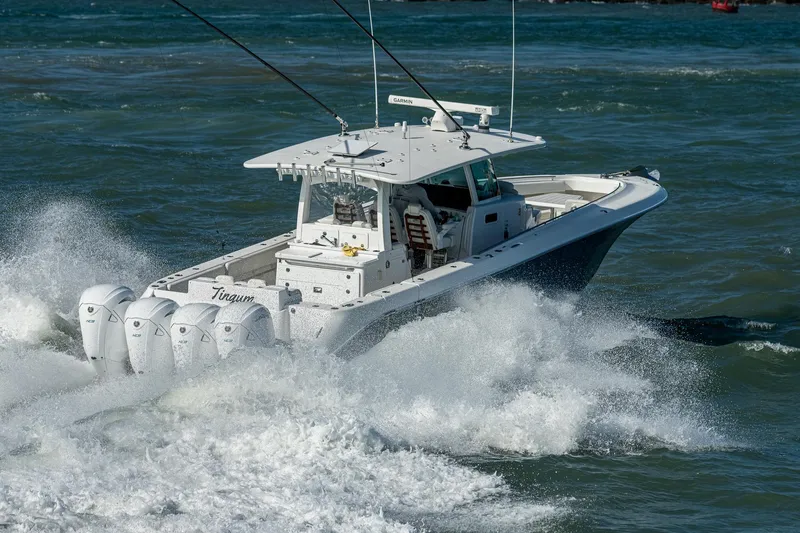 Tingum Yacht Photos Pics 2021 HCB 42 Lujo boat cruising through waves with four outboard engines.