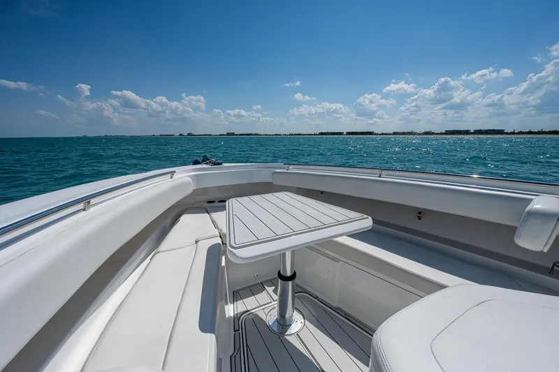 Tingum Yacht Photos Pics 2021 HCB 42 Lujo boat with seating area and table on open water.