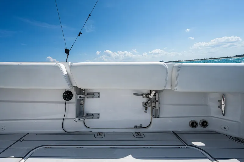 Tingum Yacht Photos Pics 2021 HCB 42 Lujo boat deck with white seating and ocean view.