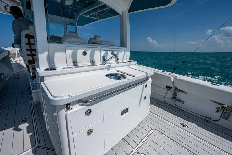 Tingum Yacht Photos Pics 2021 HCB 42 Lujo boat with sleek white deck and ocean backdrop.