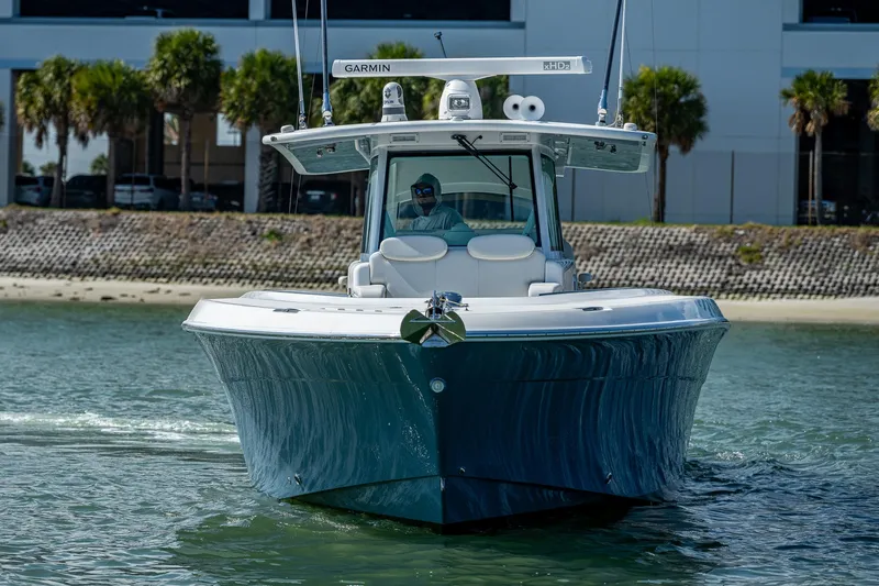Tingum Yacht Photos Pics 2021 HCB 42 Lujo boat cruising on water near shoreline.