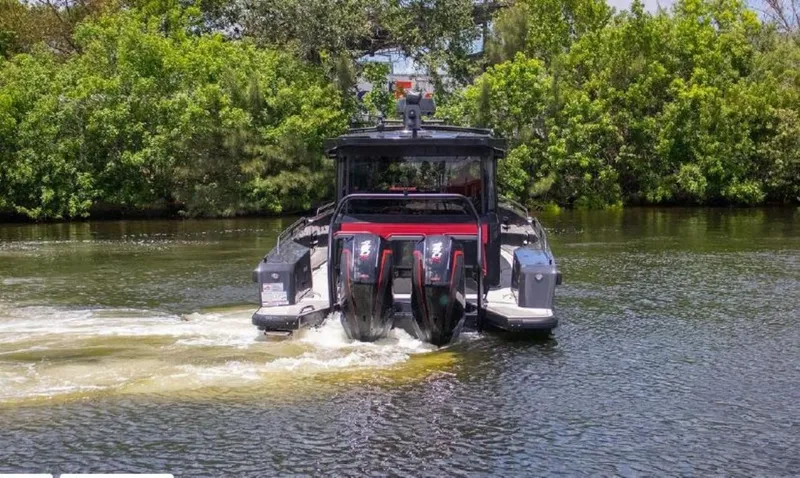  Yacht Photos Pics 2021 BRABUS Shadow 900 BO boat cruising on a river with lush greenery.