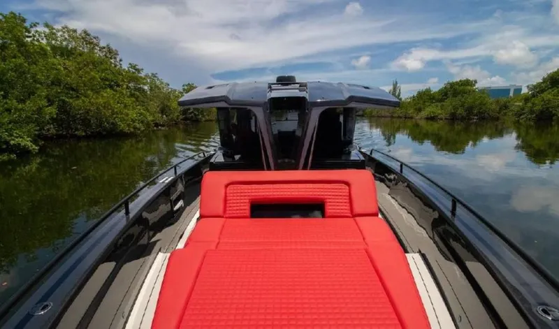  Yacht Photos Pics 2021 BRABUS Shadow 900 BO with red seating on a serene waterway.