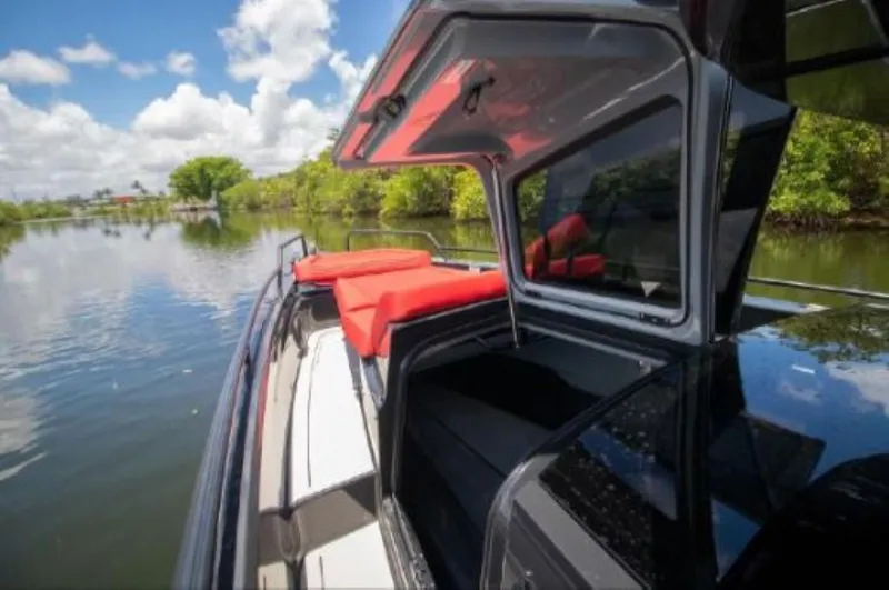  Yacht Photos Pics 2021 BRABUS Shadow 900 BO luxury boat with red seating on a scenic waterway.