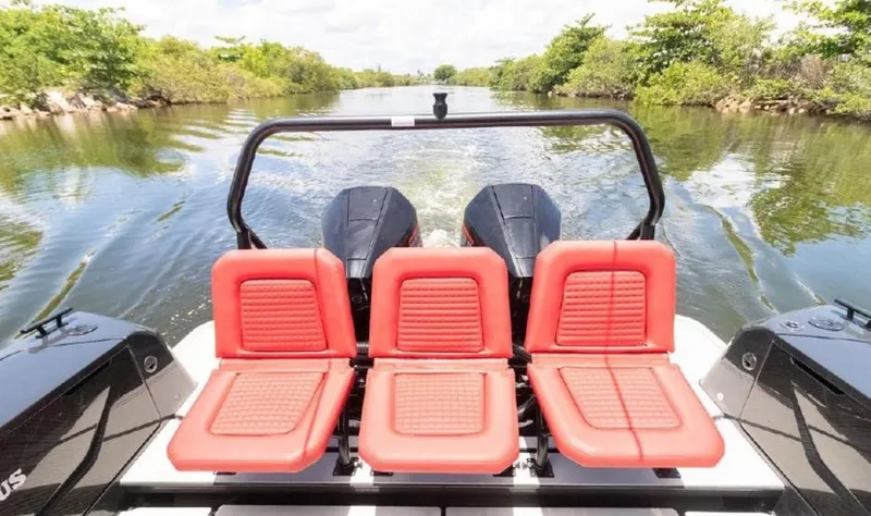  Yacht Photos Pics 2021 BRABUS Shadow 900 BO with red seats cruising on a scenic waterway.