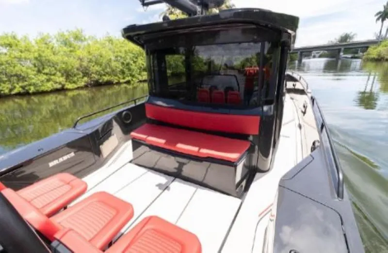  Yacht Photos Pics 2021 BRABUS Shadow 900 BO luxury boat with red seating on a calm river.